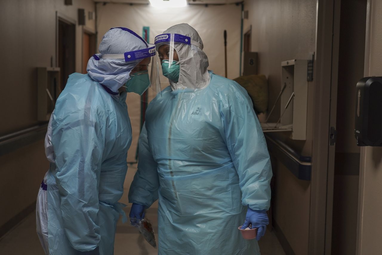 Medical staff members communicate each other in the COVID-19 intensive care unit (ICU) at the United Memorial Medical Center on December 2, in Houston, Texas. 