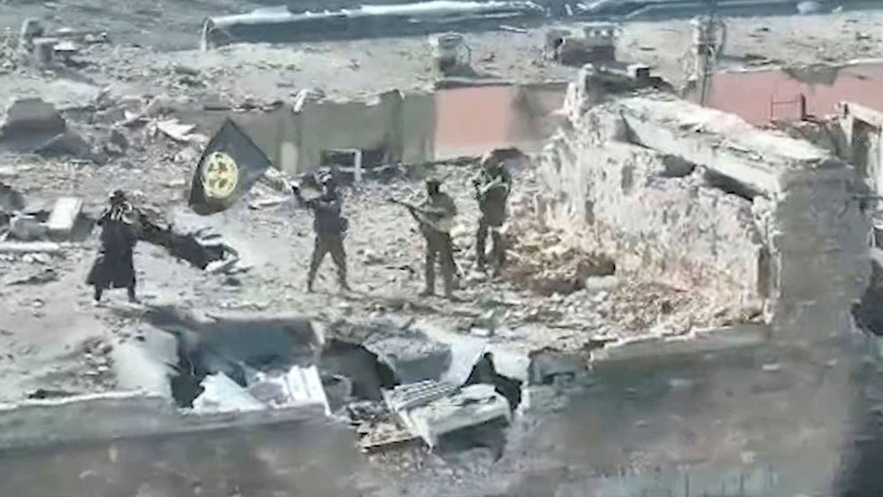 A still image taken from video released on March 2 by founder of Russia's Wagner Group Yevgeny Prigozhin's press service, shows what it said to be Wagner fighters standing with a flag on top of a building in Bakhmut. 