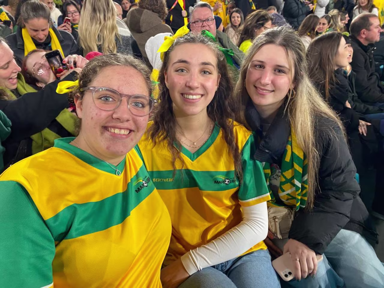 From left to right, sisters Gemma Tsaousis, Yianna Tsaousis, and friend Bettina Askounis watch on nervously in Sydney. 