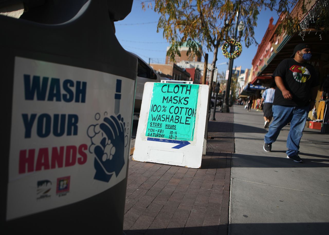 Masks are advertised near a handwashing station amid a surge of coronavirus cases in the city on November 18, in El Paso, Texas.