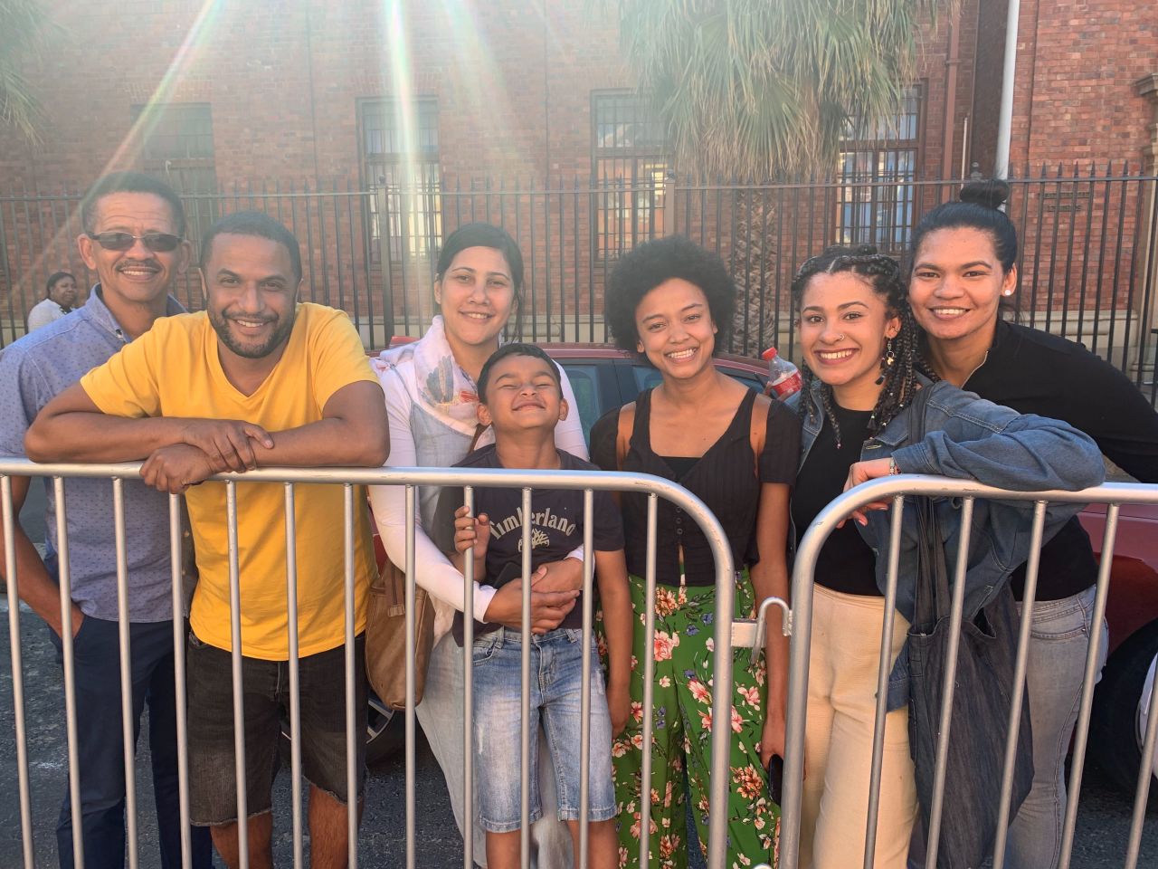 Joseph Bouman (far left, in glasses) and Alfonzo Solomon (second left, in yellow t-shirt) met the Duke and Duchess of Sussex in Cape Town on Monday. 