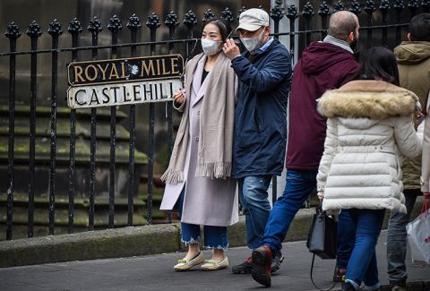 Tourists wear face masks as they visit Edinburgh Castle on January 24, in Edinburgh, Scotland. 