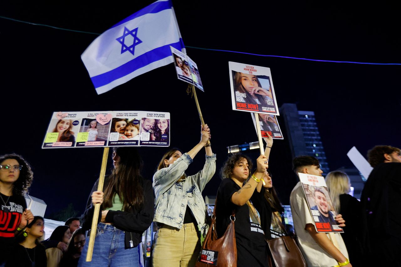 People gather as they await news of hostages expected to be released by Hamas, on November 25, in Tel Aviv, Israel. 