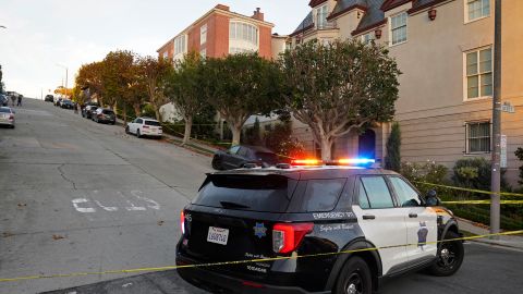 A police car blocks the street below the home of Paul Pelosi on Friday.