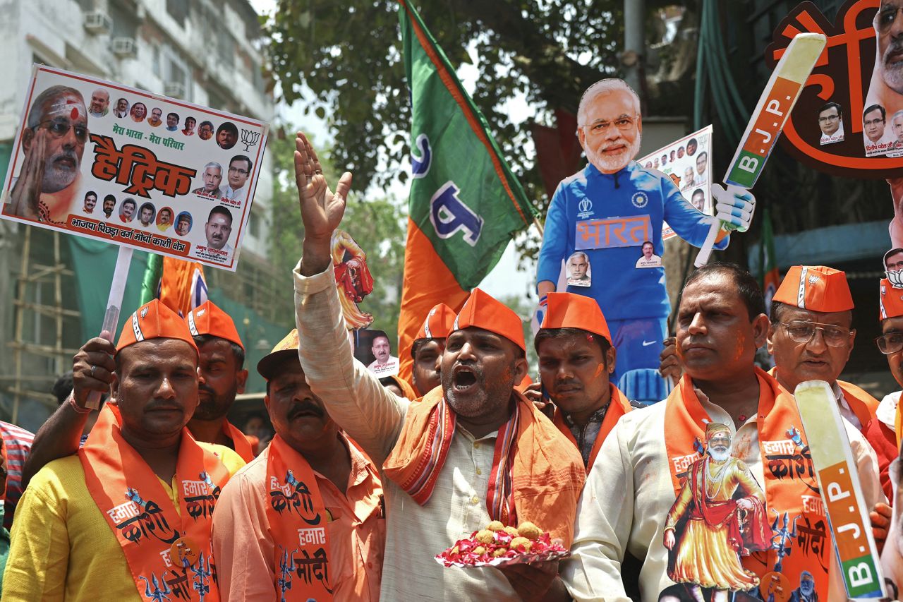 Supporters of Narendra Modi, India's Prime Minister and leader of Bharatiya Janata Party, carry his cut-out as they celebrate vote counting results for India's general election in Varanasi, India, on June 4.