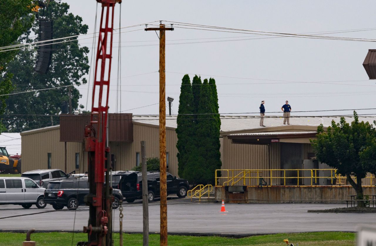 FBI investigators work at the scene of the attempted assassination of former President Donald Trump in Butler, Pennsylvania, the day after shots were fired during a campaign rally.