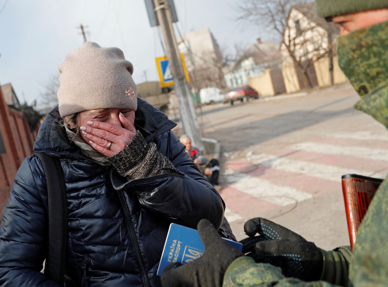 Local resident Inga Serbina, 45, has her passport checked by a service member of pro-Russian troops before she leaves the city of Mariupol, Ukraine, on March 27.