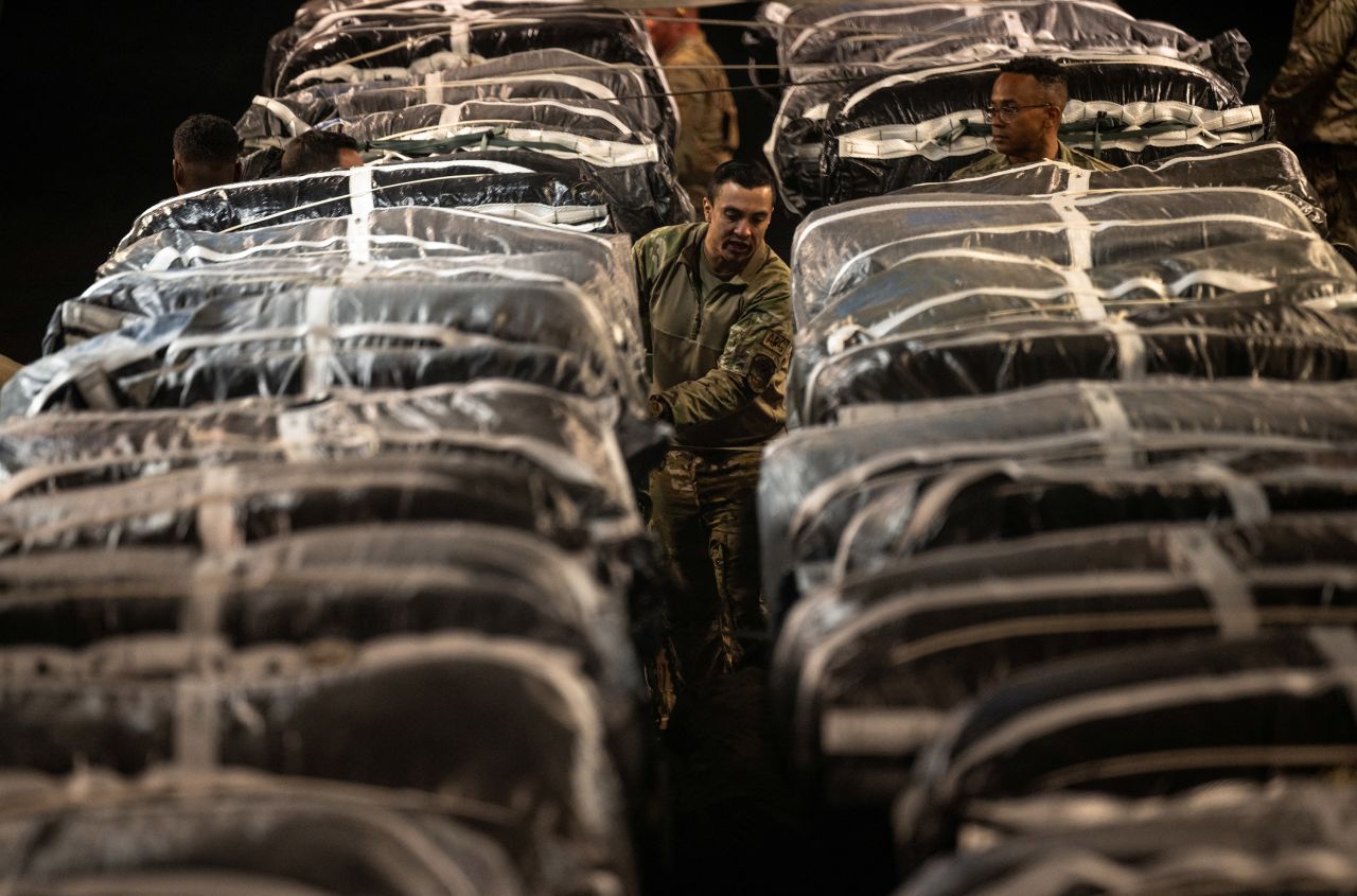 US service members secure humanitarian aid, bound for airdrop over Gaza, onto a cargo aircraft at an undisclosed location on March 1.  