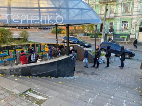 People line up with plastic bottles at a water distribution center in central Kyiv, after Russia's strikes left water outages across the city.