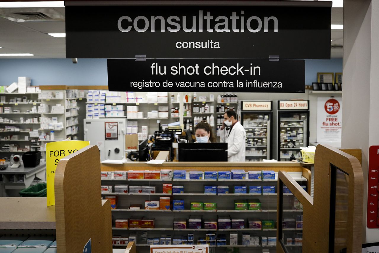 A "flu shot check-in" sign is displayed at a CVS Pharmacy in Miami, on September 30, 2020.