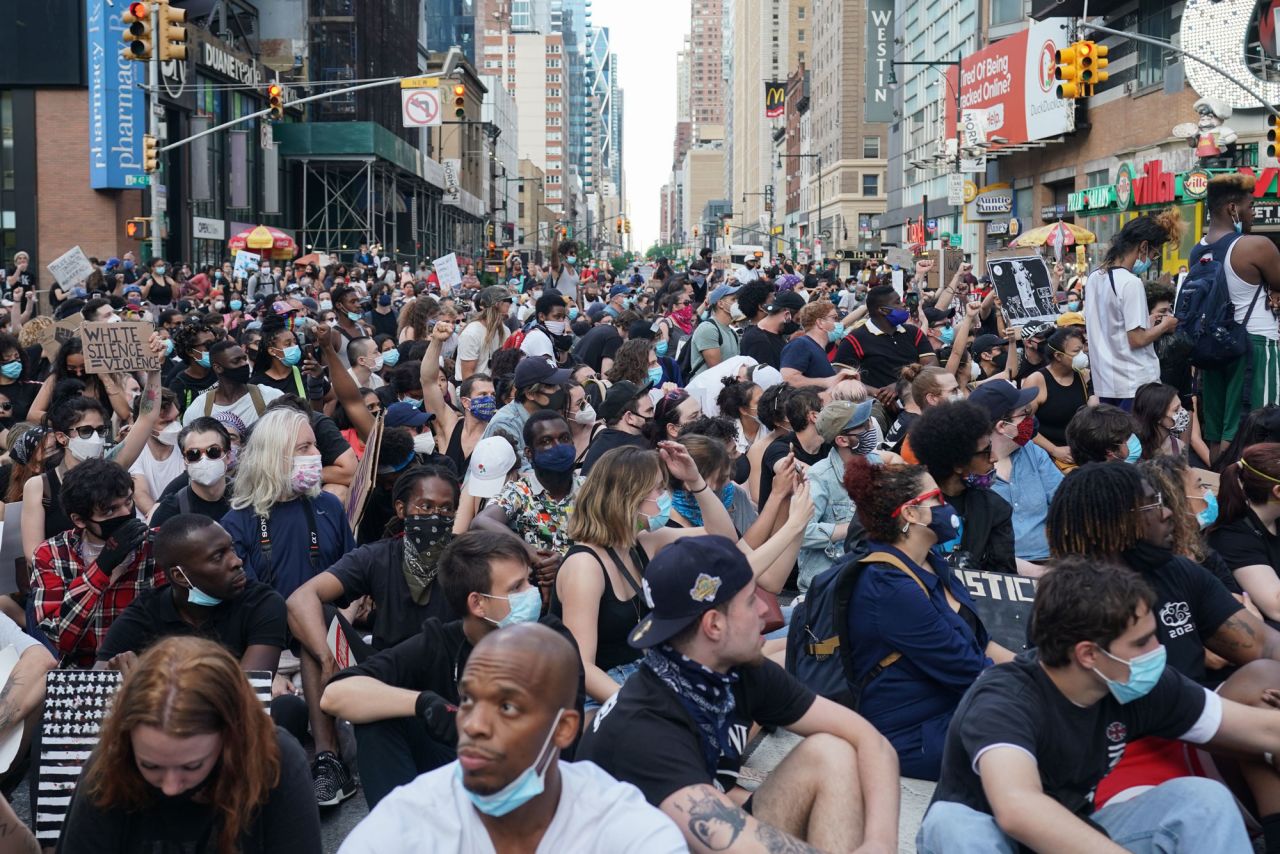 Protesters sit in the middle of the intersection of 42nd Street near Times Square on June 7 in New York. 