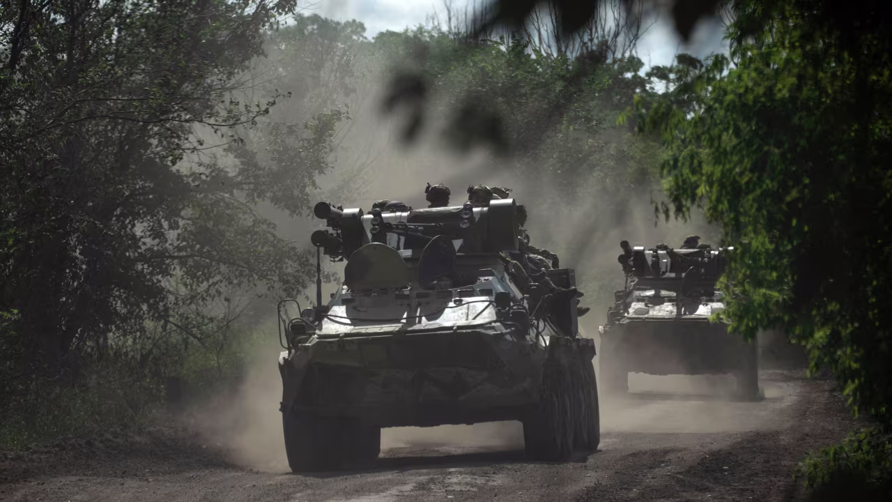 Ukrainian servicemen ride on armored personnel carriers on a road toward Bakhmut in the Donetsk region of Ukraine on July 1.