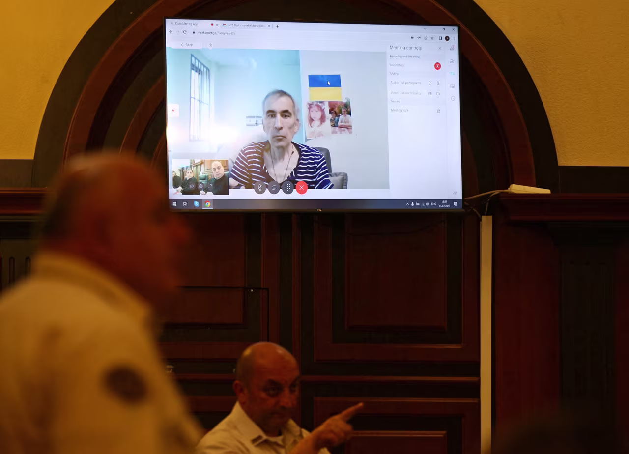 Georgia's jailed ex-President Mikheil Saakashvili appears on a screen via a video link from a clinic during a court hearing in Tbilisi, Georgia, on July 3.