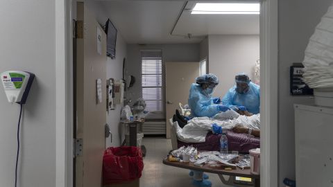 Medical staff members treat a patient suffering from the coronavirus disease in the Covid-19 intensive care unit at the United Memorial Medical Center on November 19 in Houston.