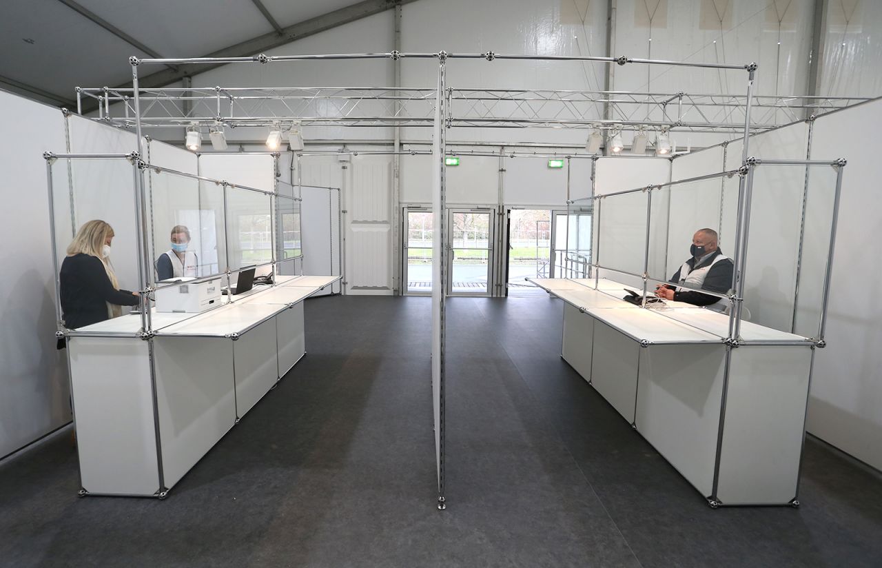 Members of aid organizations stand in the entrance area of the joint vaccination center of the city and district of Würzburg, Germany on December 16.