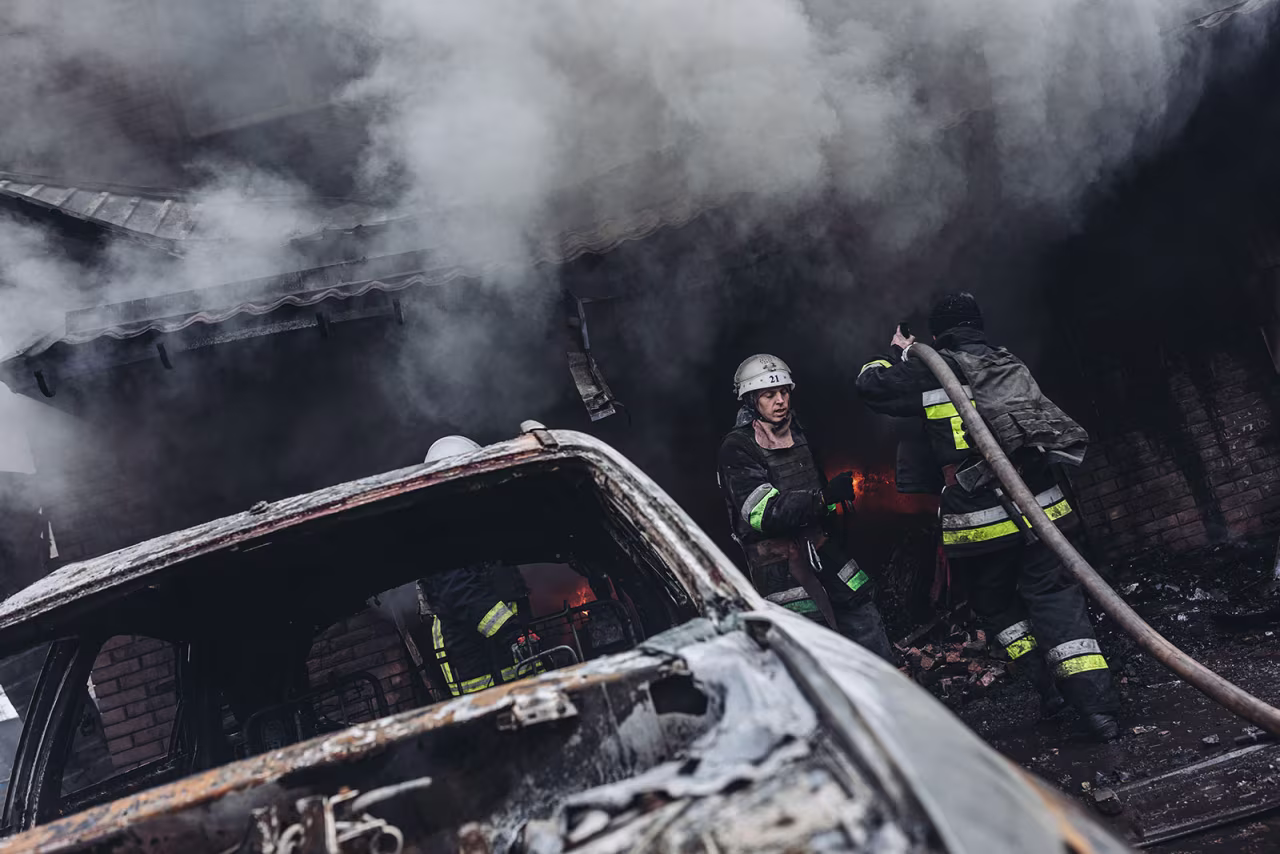 Firefighters try to extinguish a fire in a house damaged by Russian shelling in Kharkiv on April 3.
