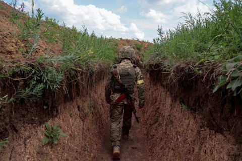 A Ukrainian serviceman walks in a trench in Donbas, on Sunday.
