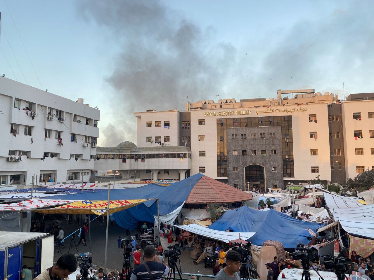 Smoke rises as displaced Palestinians take shelter at Al-Shifa Hospital in Gaza City on November 8.