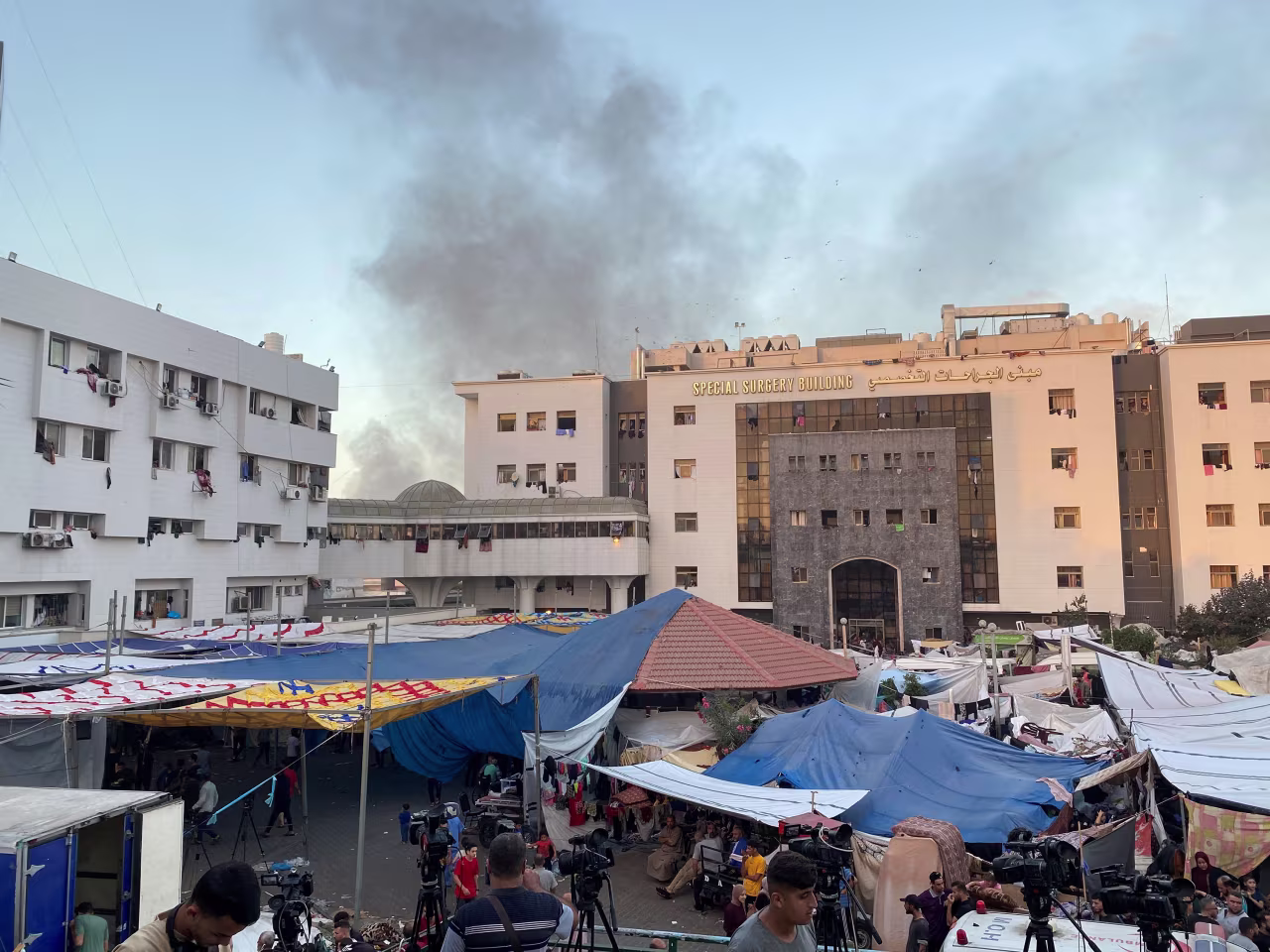 Smoke rises as displaced Palestinians take shelter at Al-Shifa Hospital in Gaza City on November 8.