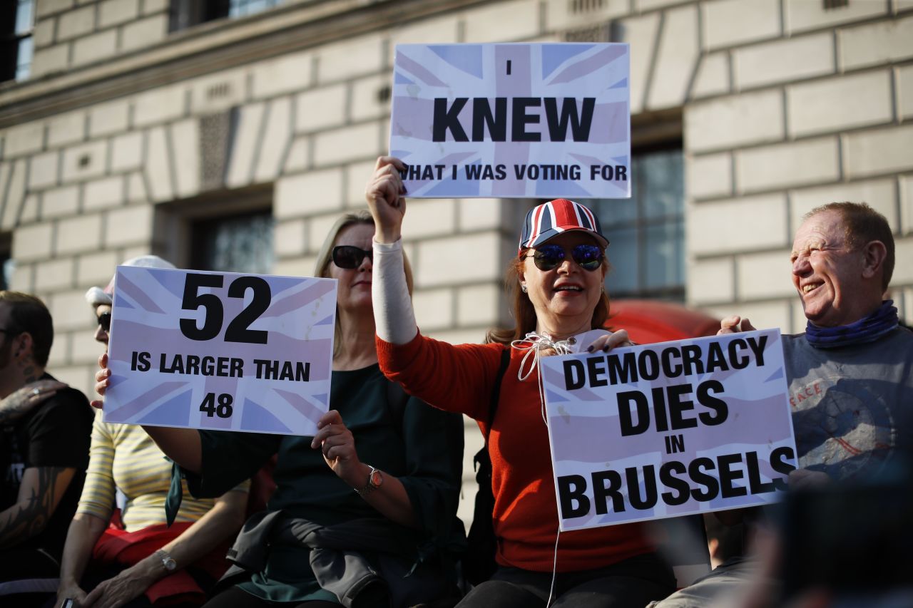 Pro-Brexit demonstrators hold up placards in central London on Friday after MPs rejected May's Withdrawal Agreement for a third time.