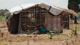 A woman sits outside a makeshift shelter at the Eduardo Mondlane camp for the internally displaced, outside Mueda town, northern Mozambique. Many new arrivals who have fled the recent ISIS offensive build new homes from bamboo and tarpaulins, bound together with used fishermen’s netting, and enter the camps with almost no food or possessions.