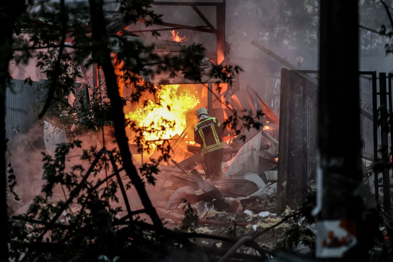 Ukrainian rescue service members work at the site of a missile strike on a residential area, in Kyiv, Ukraine, on September 21.