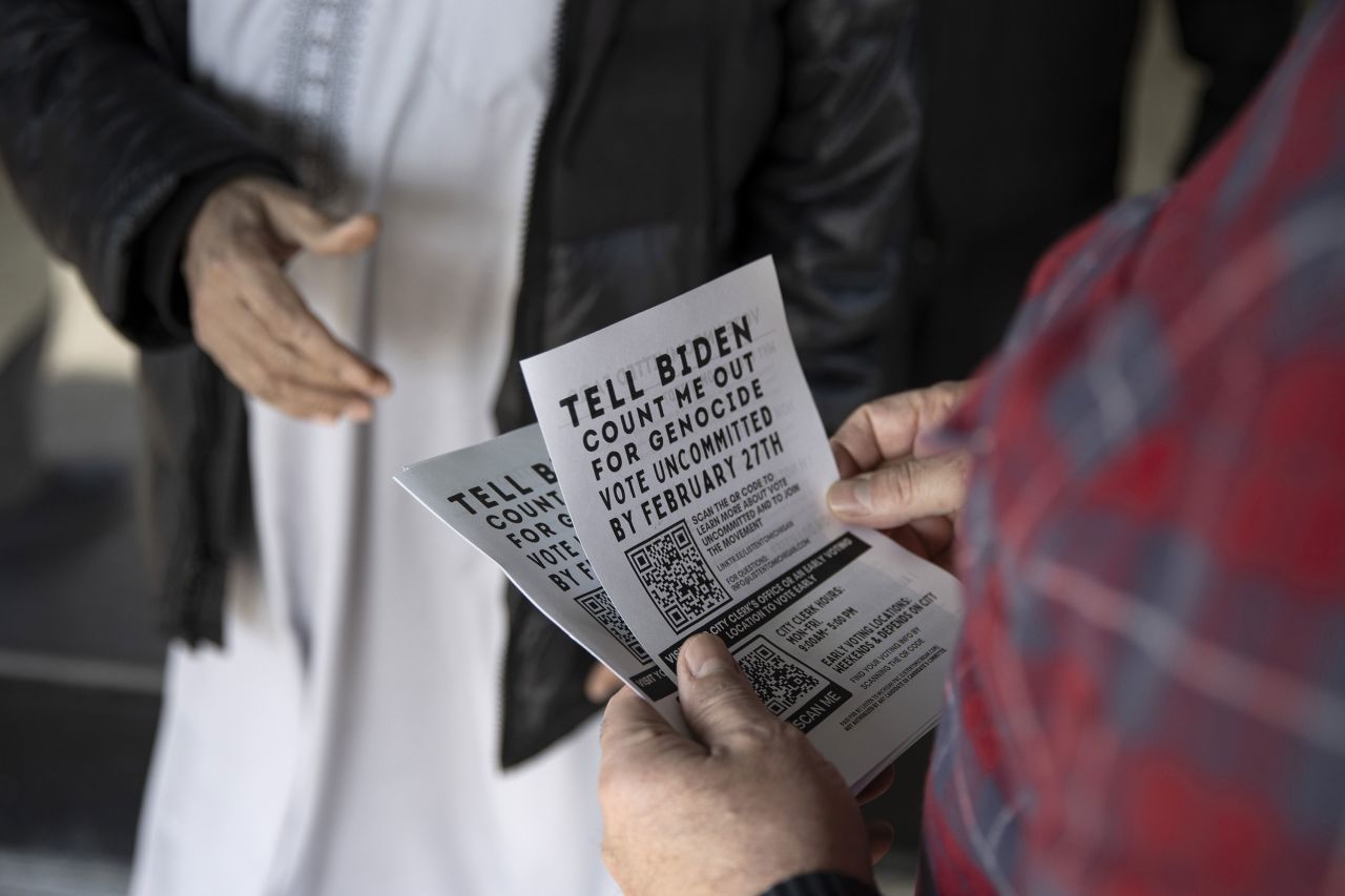 A man hands out fliers on Monday outside the Islamic Center of Detroit to ask voters to vote 'uncommitted' in the Michigan primary.