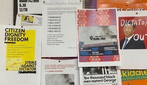 Anti-Xi posters on a notice board at a university campus in London.