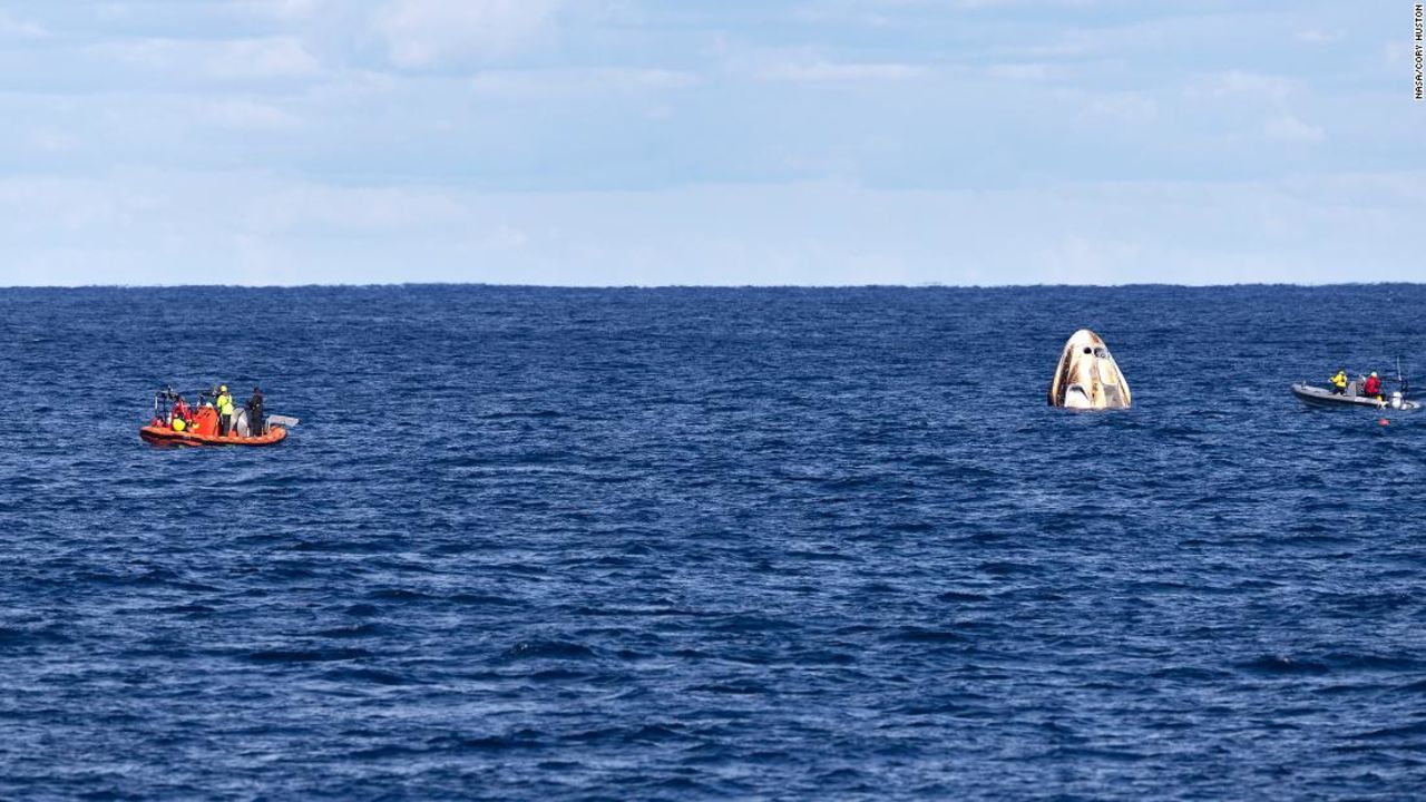 Crew Dragon, seen here after splashing down from an uncrewed test mission last year, will bob up and down until a recovery ship can haul it out of the water.