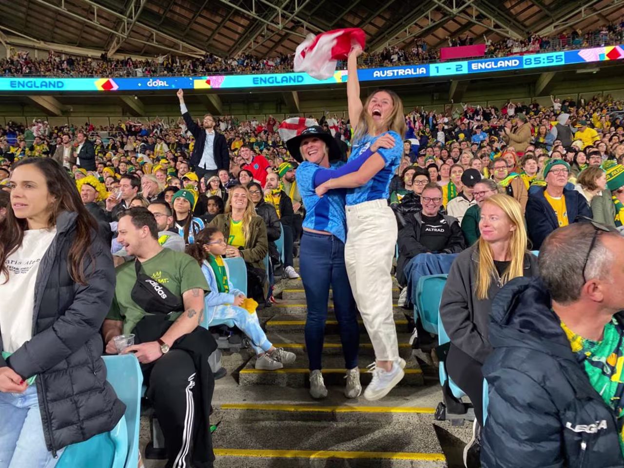 England fans celebrate inside Stadium Australia during the semifinal after Alessia Russo's game-sealing goal. 