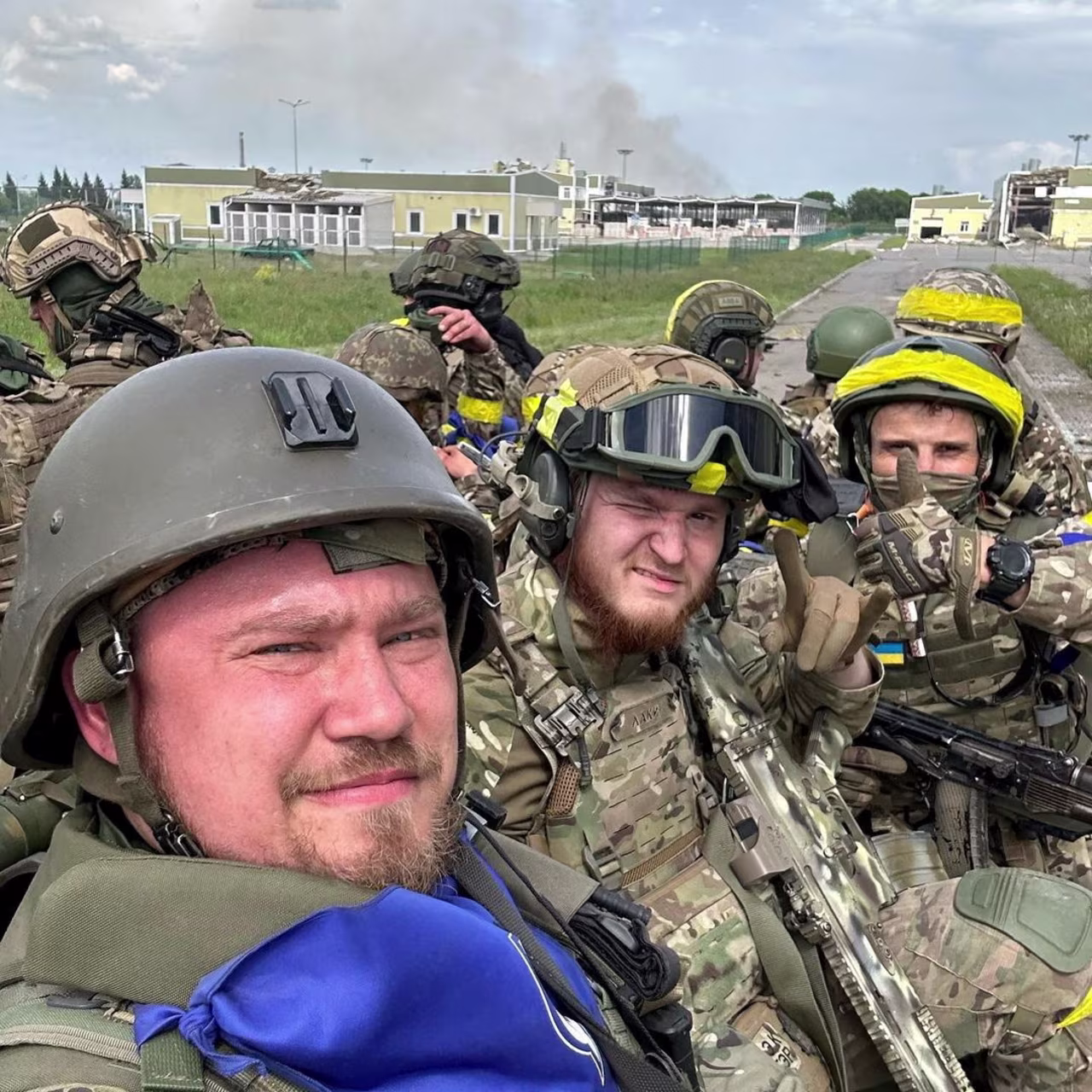 Members of Russian Volunteer Corps pose for a picture atop an armoured vehicle at Graivoron border crossing in Kozinka, Belgorod region, Russia, in this handout picture released on May 23.