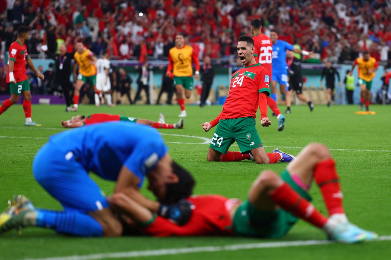 Morocco's Badr Benoun cheers with teammates after their victory. 