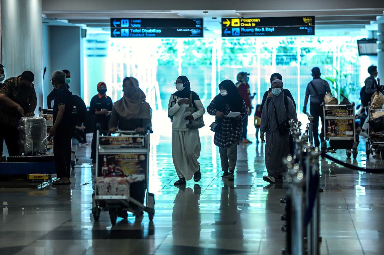 Travelers arrive at Sultan Mahmud Badaruddin II airport in Palembang, Indonesia on December 23.