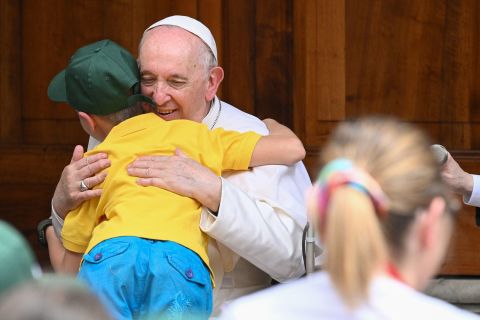 Pope Francis hugs a child refugee from Ukraine at the Vatican, on Saturday.