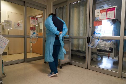 A healthcare worker puts on PPE on the Covid-19 ICU floor of the University of Massachusetts Memorial Hospital in Worcester, MA, on Monday, Dec. 27.