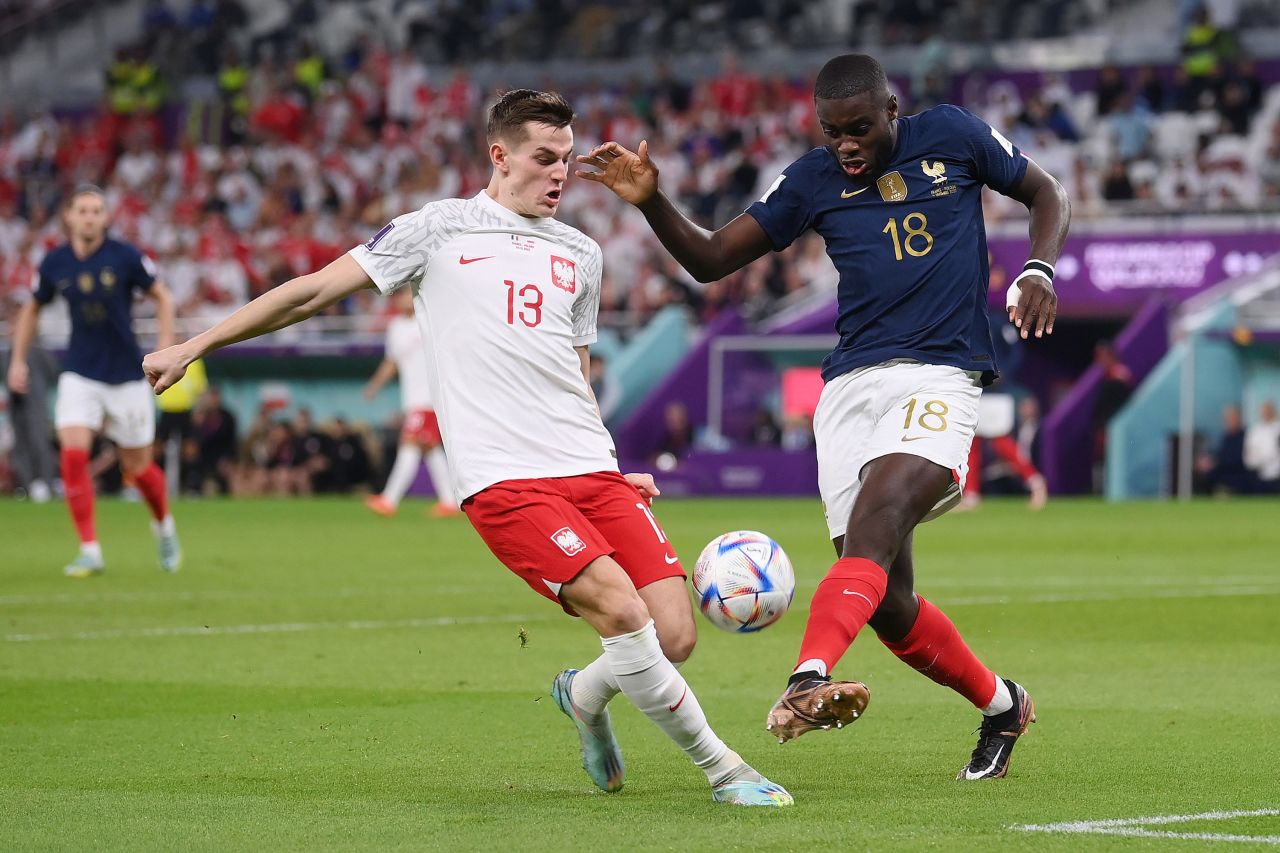 Poland’s Jakub Kaminski and France’s Dayot Upamecano compete for the ball on Sunday, December 4. 