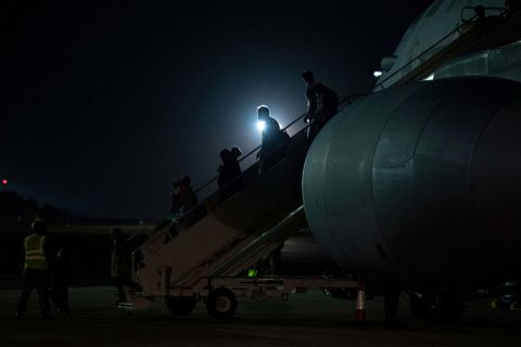 Passengers evacuated from Afghanistan disembark from a British Royal Air Force aircraft after landing at RAF Brize Norton station in England on August 24.