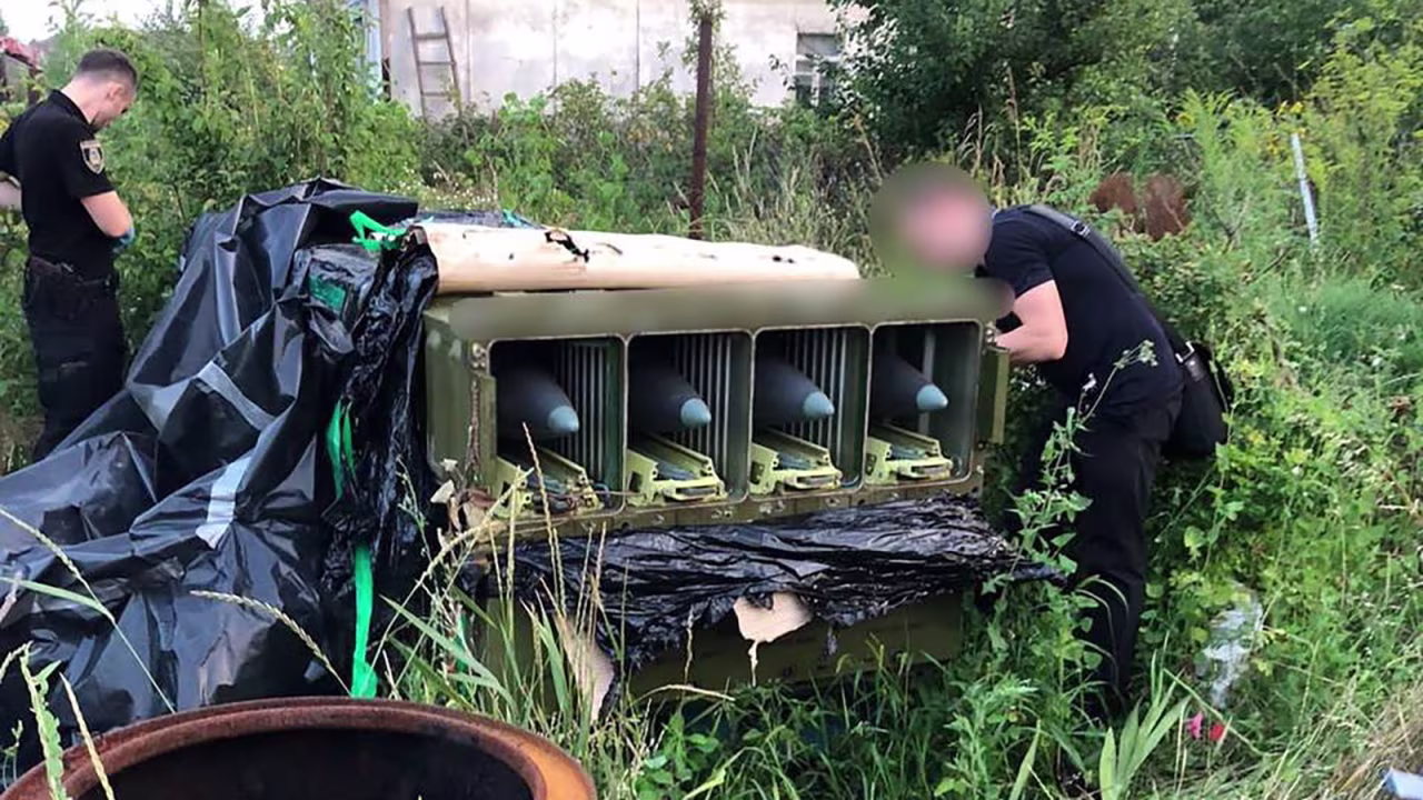 Police officers inspect weapons believed to have been left behind by Russian troops. Portions of this photo have been blurred by the source. 