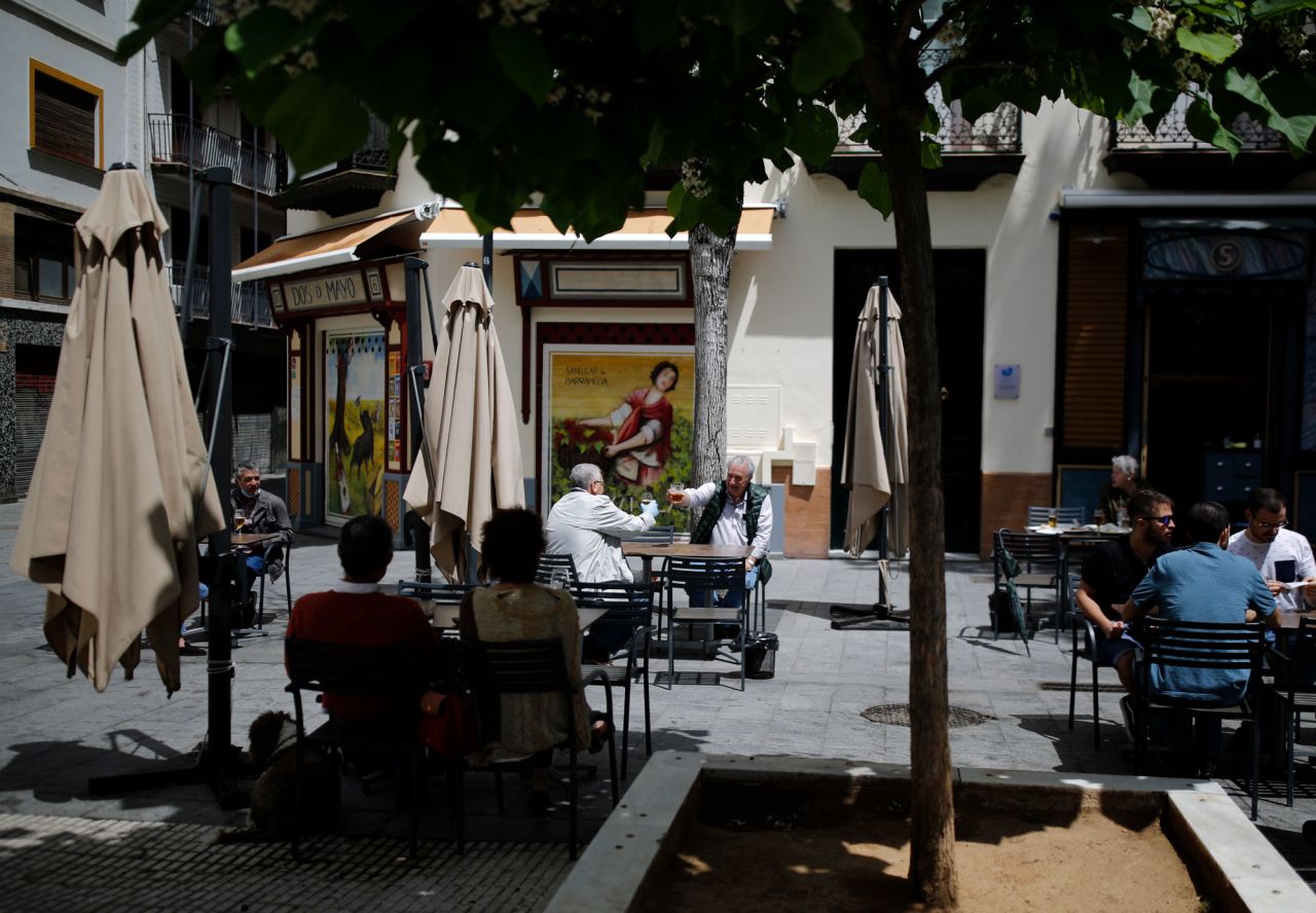 People sit at a terrace of a bar on May 11 in Seville, Spain. 