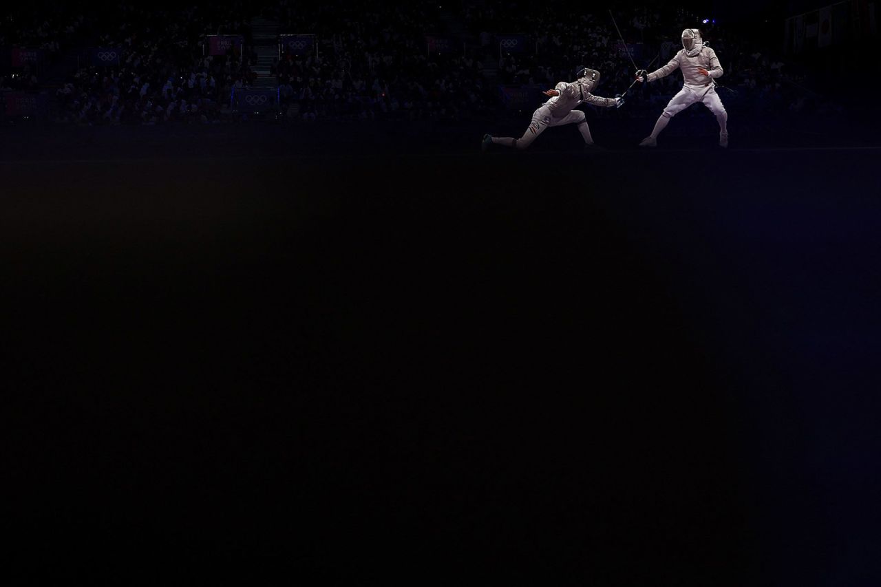 Hungarian fencer Krisztian Rabb, left, faces South Korea's Park Sang-won on July 31. South Korea won gold in the team sabre event. 