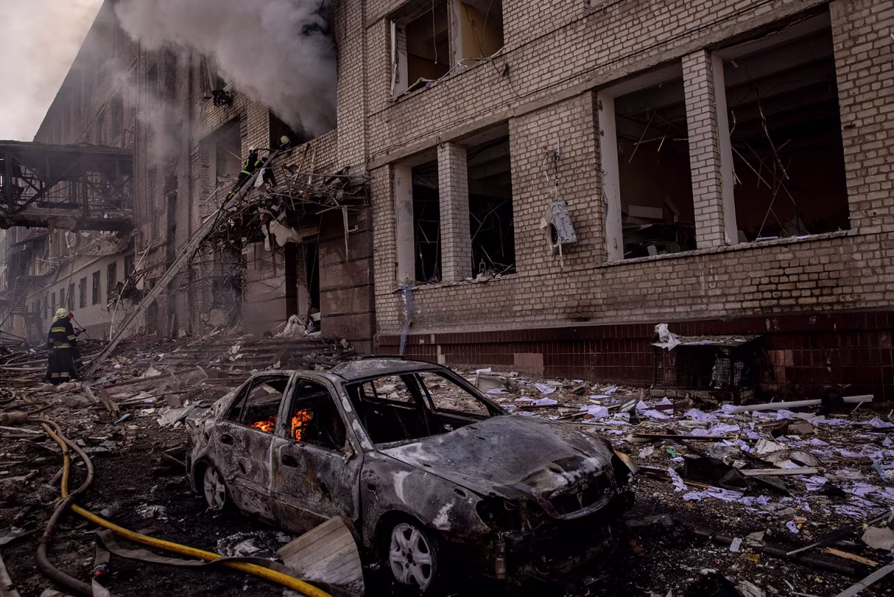Firefighters work to extinguish a fire at a shopping center and surrounding buildings after a Russian missile strike on Saturday, April 16, in Kharkiv, Ukraine. 