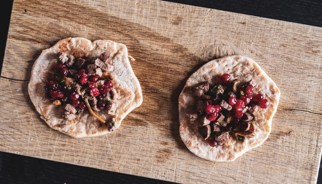 Gáhkku with suovas and lingonberries.