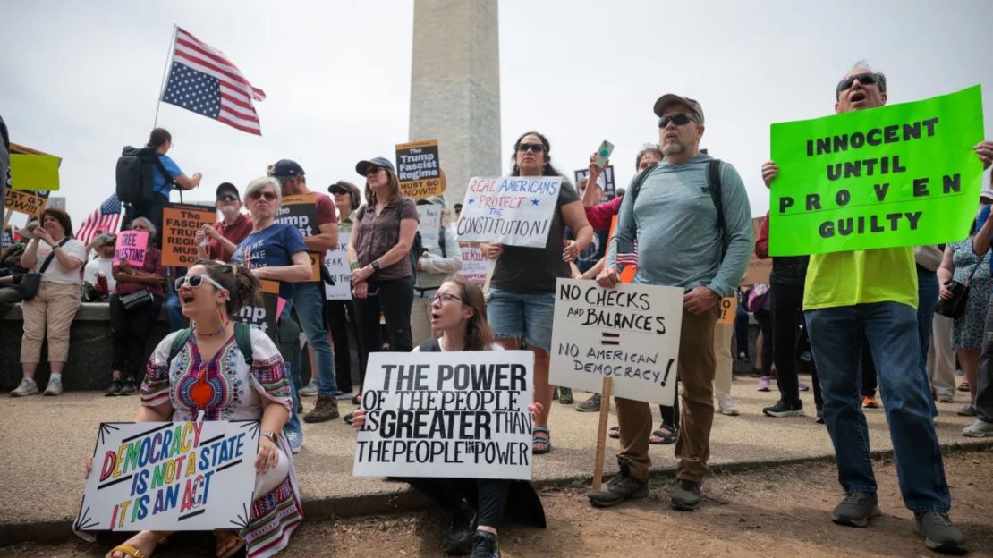 Heather Sarandos (centro), de Baltimore, sostiene un cartel mientras grita durante la protesta en contra de Trump el 19 de abril de 2025 en Washington.
