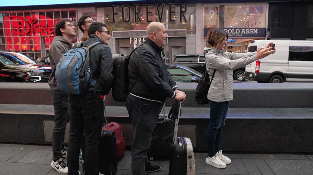 Eman Moretti, far left, and his family pose for a group photo in Times Square.