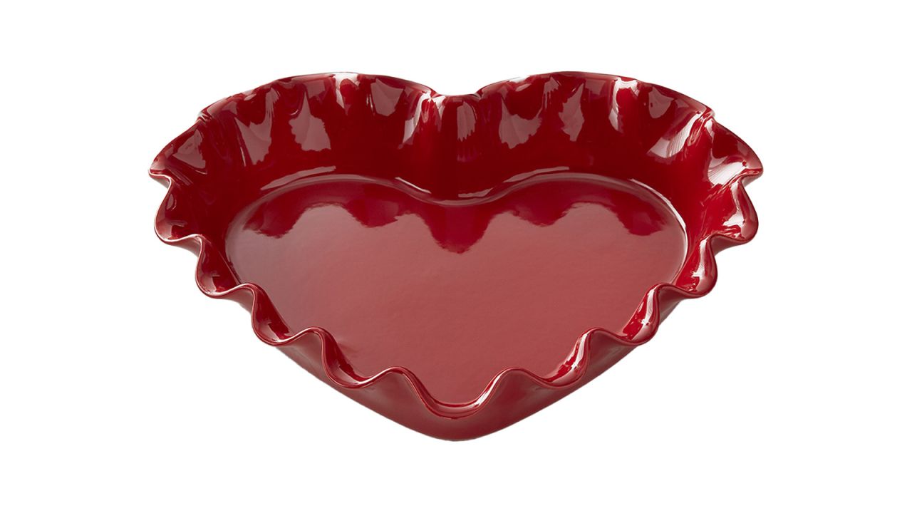 A red, heart-shaped pie dish with ruffled edges.
