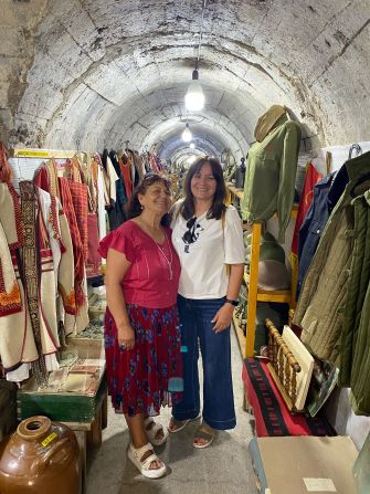 <strong>Underground antiquities: </strong>Tour guide Eni Koco, right, poses with Manushaque Zhuli, who has set up a business showcasing historical items in a bunker in Gjirokaster.