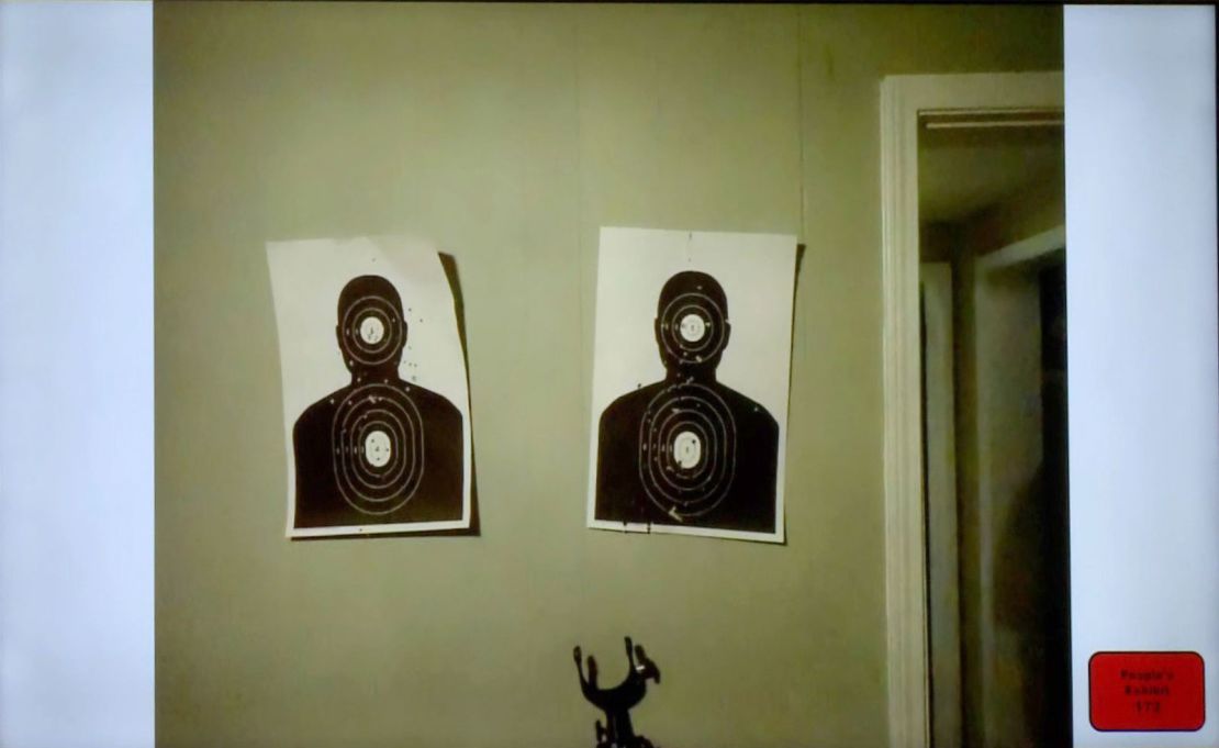 Two bullet-riddled gun range targets were affixed to the wall in Ethan's room.