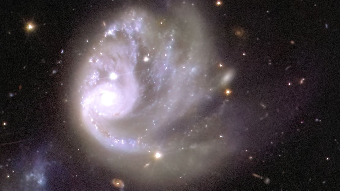 La estructura espiral de una galaxia dentro del cúmulo de galaxias Abell 3381 se puede ver dentro del mosaico con un aumento de 150x.