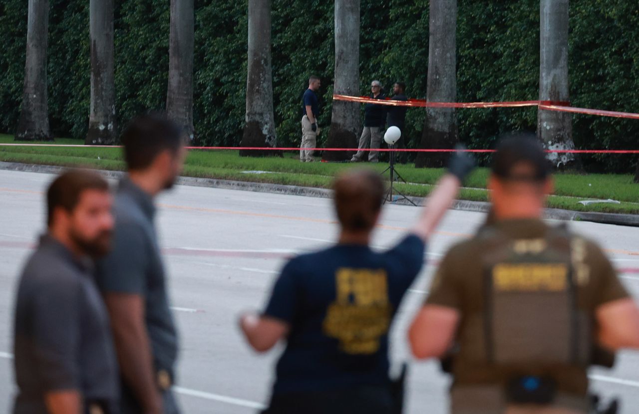 Law enforcement personnel investigate the area around Trump International Golf Club  in West Palm Beach, Florida, after an apparent assassination attempt of former President Donald Trump on September 15, 2024