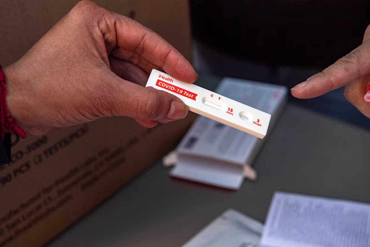 Volunteers explain how to use a rapid at-home Covid-19 test in Chelsea, Massachusetts, on December 17, 2021. 